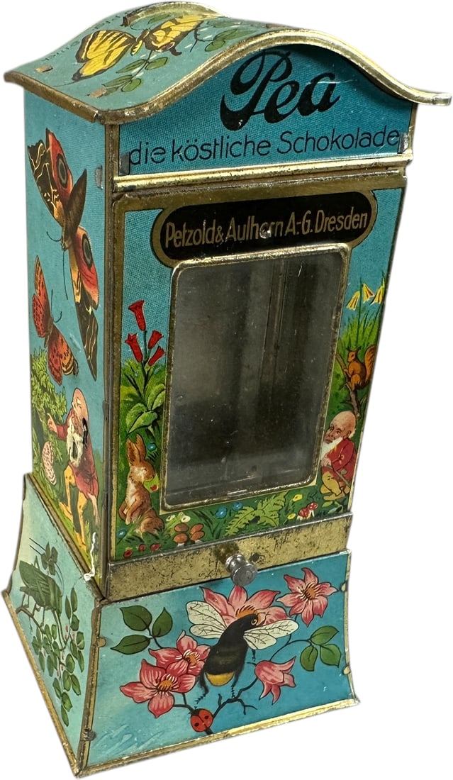 PEA CHOCOLATE VENDING BANK: 1354. PEA CHOCOLATE VENDING BANK | Bright colored lithography of butterflies adorn the sides of this sweet bank. Provenance: The Maloy Collection. | 6" h. | (Pristine Condition) | $400 - $600