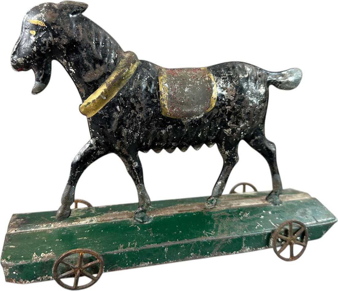 GEORGE BROWN GOAT ON PLATFORM: 1415. GEORGE BROWN GOAT ON PLATFORM | Provenance: The Maloy Collection. | 9" l. | All original paint with only one hoof resoldered to base, (Very Good Condition) | $250 - $500