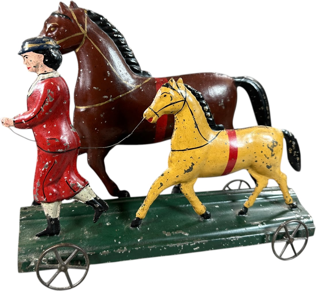 AMERICAN TIN WOMAN W/ TWO HORSES ON PLATFORM: 1421. AMERICAN TIN WOMAN W/ TWO HORSES ON PLATFORM | Provenance: The Maloy Collection. | 10.5" l. | Professionally restored to correct colors and aged to display as (Excellent Condition) | $600 -