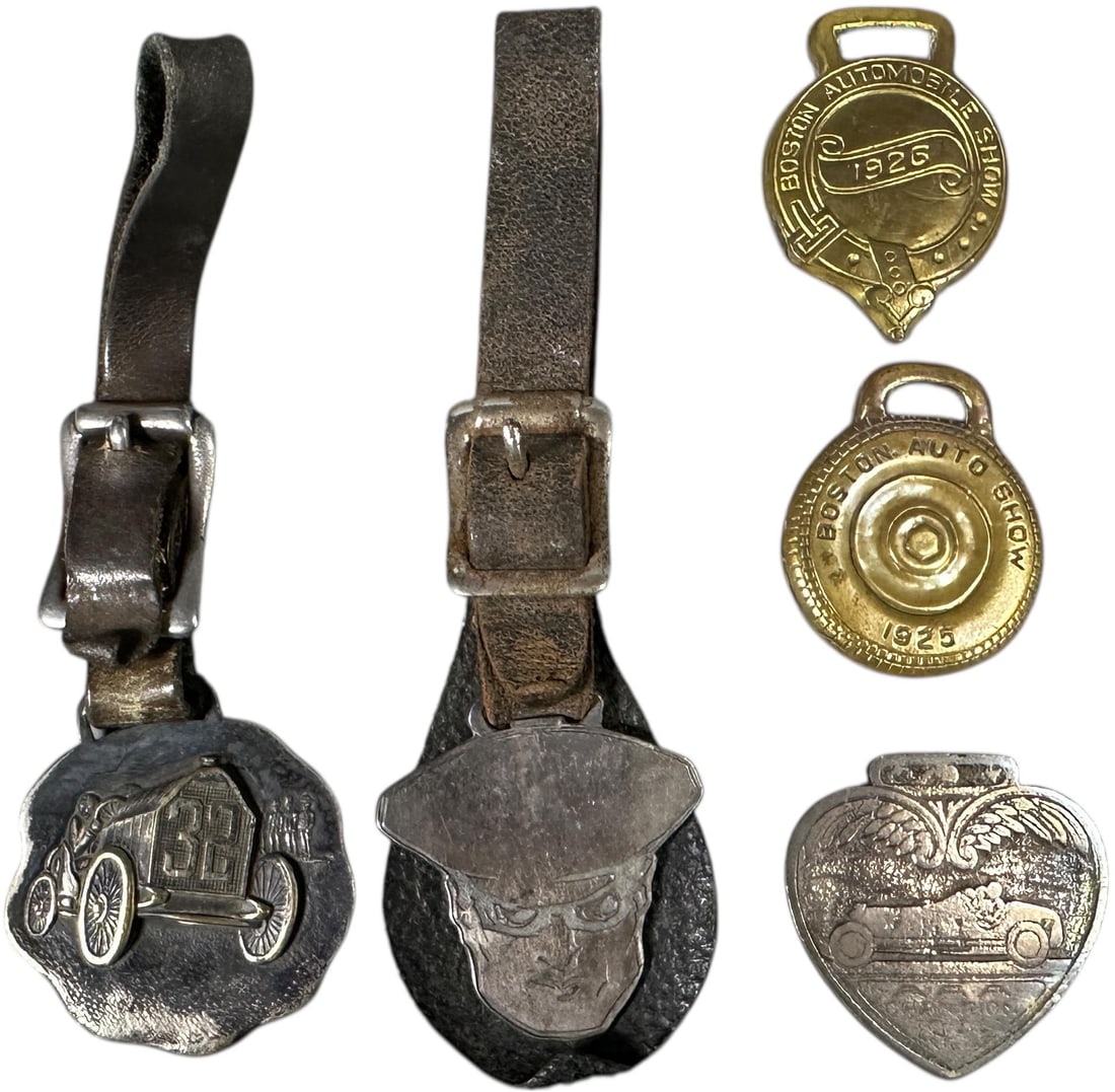 FIVE MOTORING-RELATED ACCESSORIES: 209. FIVE MOTORING-RELATED ACCESSORIES | 1934 Oilzum AAA Award; 2 Boston Automobile show watch fobs 1923/1926; Boston Garage watch fob. From the David Bausch Automobilia Collection. | 4" l. | (Very