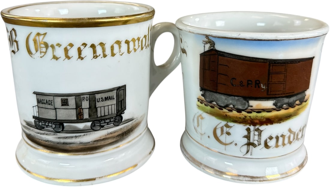 TWO RR CAR OCCUPATIONAL SHAVING MUGS: 221. TWO RR CAR OCCUPATIONAL SHAVING MUGS | Occupational shaving mugs were personalized for regular patrons and kept at the barber shop for repeated use. Hand-painted scenes identifying the owner's