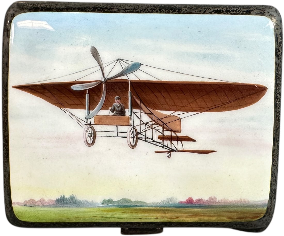 ENAMELED STERLING AVIATION CIGARETTE CASE: 236. ENAMELED STERLING AVIATION CIGARETTE CASE | Marked 925 featuring image of a very early airplane. From the David Bausch Automobilia Collection. | 3.5" l. | Overall in (Excellent Condition) with a