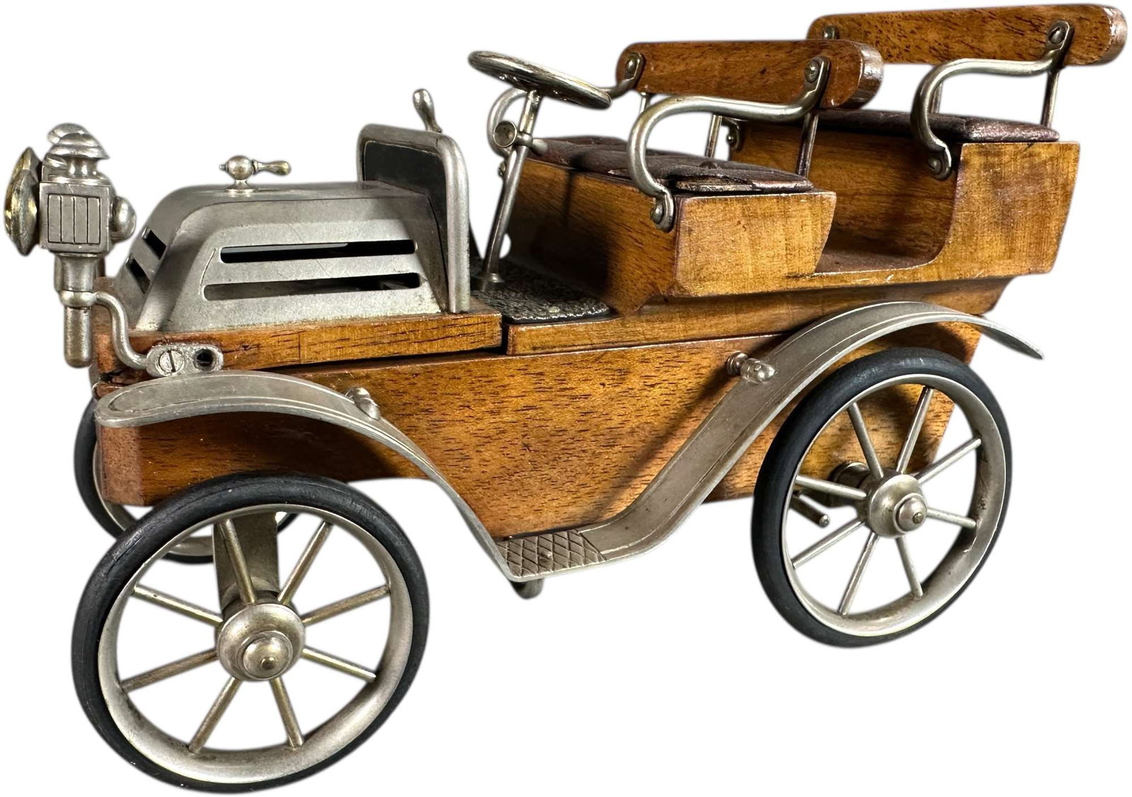 WOOD AUTOMOBILE CIGARETTE BOX WITH MATCH HOLDER: 365. WOOD AUTOMOBILE CIGARETTE BOX WITH MATCH HOLDER | Novelty cigarette box in the form of an open automobile, featuring hardwood body with nickel-plated fenders, radiator, lamps, and spoked wheels. 