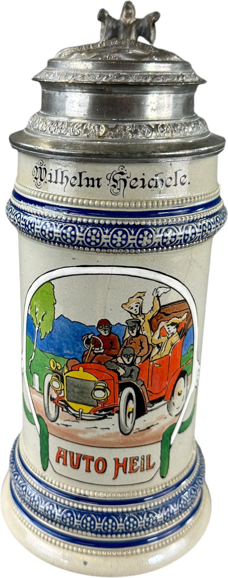 GERMAN AUTOMOBILE STEIN: 493. GERMAN AUTOMOBILE STEIN | Marked Wilhelm Heichele; Auto Heil ('Long live the Automobile!') From the David Bausch Automobilia Collection. | 9.5" h. | Slight cracking, (Pristine Condition) | $200 -