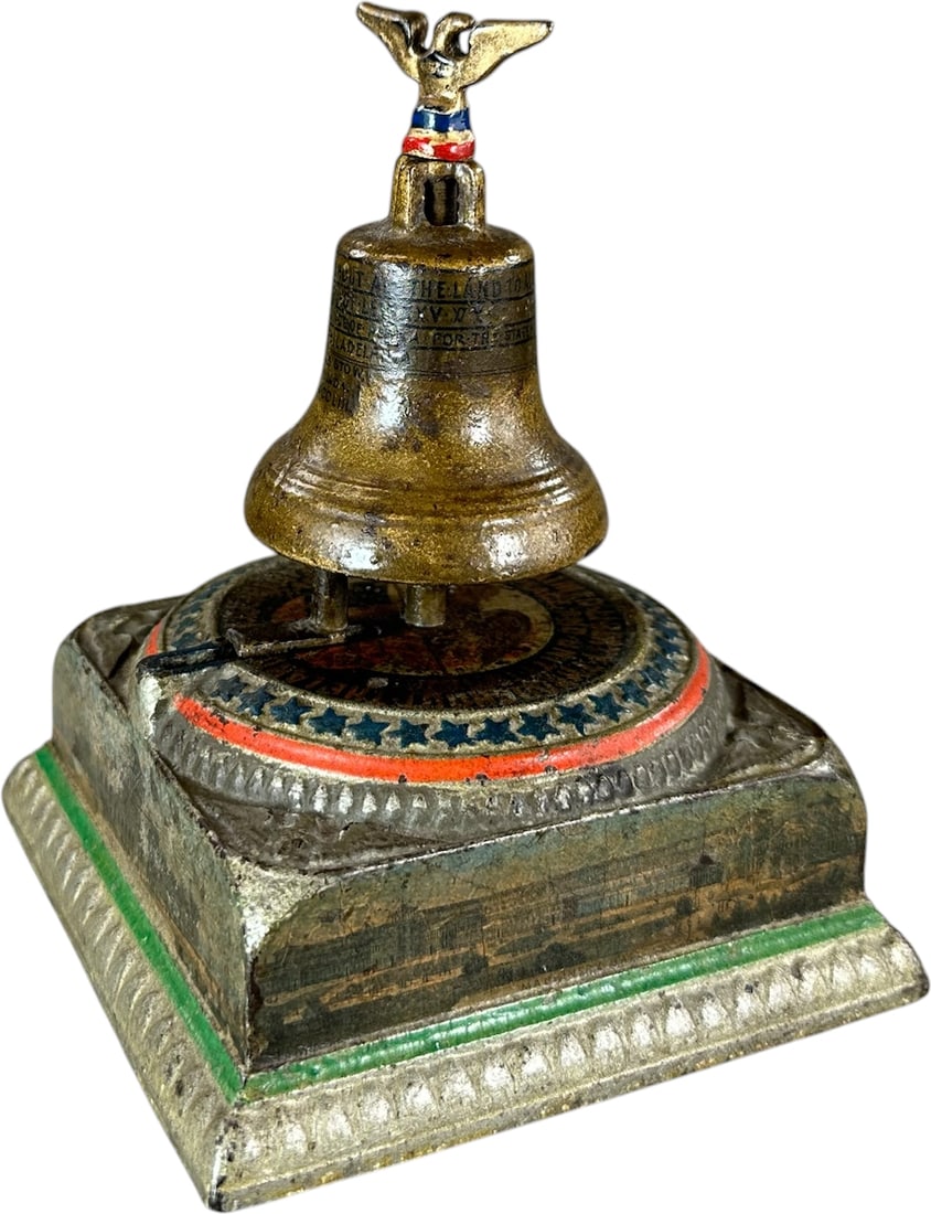 MEMORIAL BELL MONEY BANK: 6. MEMORIAL BELL MONEY BANK | Enterprise Mfg. Co., Philadelphia PA. Provenance: The Robert Booth Jr. Collection. | 6.5" h. | Strong colors throughout the bank, screw-on eagle finial is the typical rep