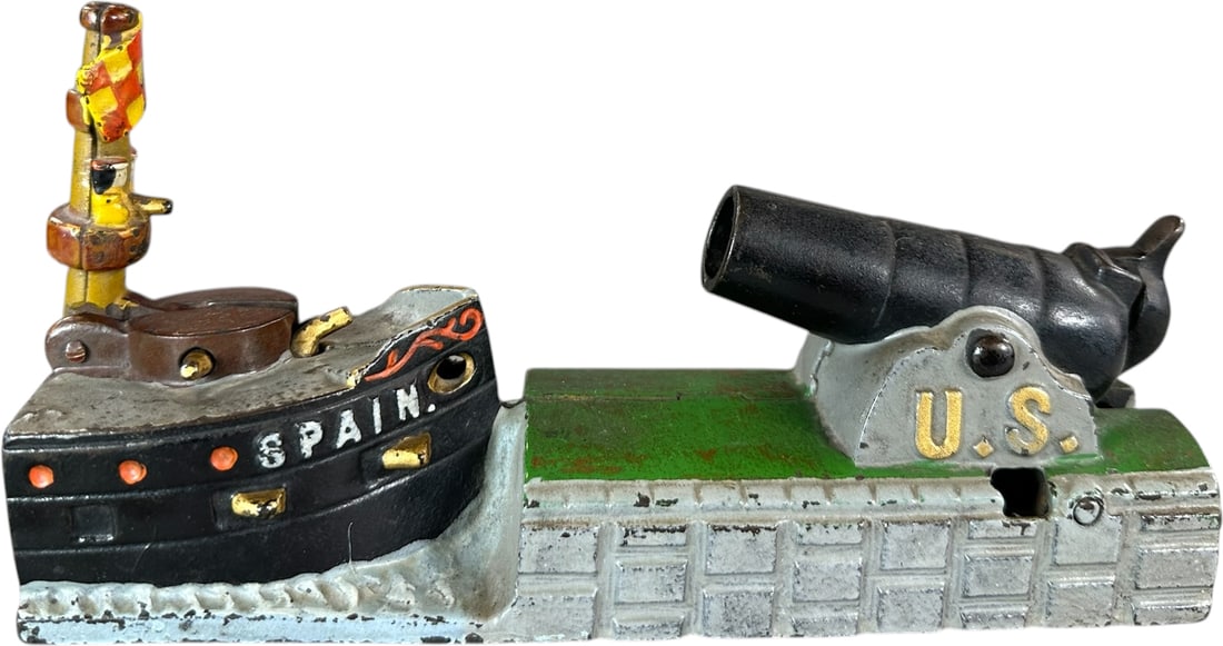 US SPAIN MECHANICAL BANK: 8. US SPAIN MECHANICAL BANK | J&E Stevens Co., popular bank with original mast and complete original paint, a certain favorite amongst collectors. Provenance: The Robert Booth Jr. Collection. | 8.5" l