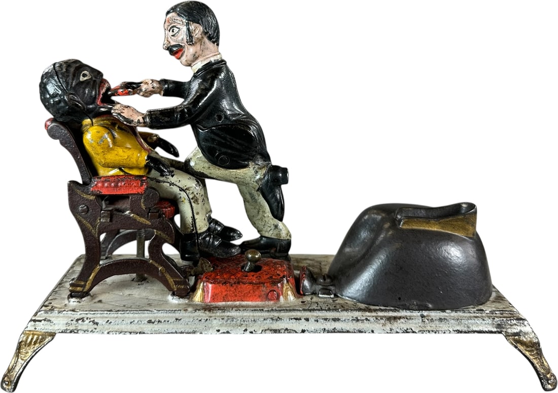 DENTIST MECHANICAL BANK: 17. DENTIST MECHANICAL BANK | J&E Stevens Co. Provenance: The Robert Booth Jr. Collection. | CULTURAL DISCLAIMER: Certain antique and vintage items in this sale include imagery or themes that reflect 