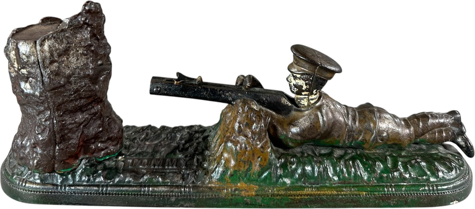 TOMMY MECHANICAL BANK: 39. TOMMY MECHANICAL BANK | John Harper & Co., England, circa 1914, a scarce shooting bank depicting Tommy, a WWI British soldier. Provenance: The Robert Booth Jr. Collection. | 11" l. | Base crack at