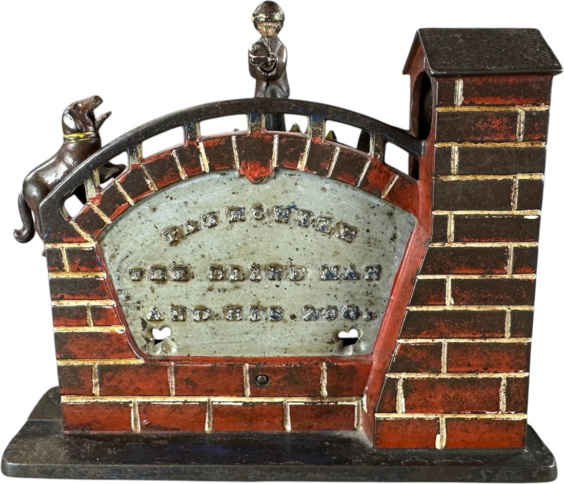 PATRONIZE THE BLIND MAN MECHANICAL BANK: 43. PATRONIZE THE BLIND MAN MECHANICAL BANK | J&E Stevens Co., scarce bank, whimsical action of a blind man hiding his last coin as a dog swiftly snatches it out of his hands. Provenance: The Robert B