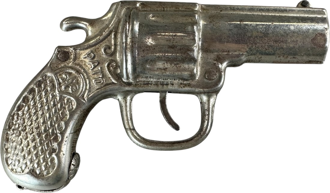 PISTOL MECHANICAL BANK: 102. PISTOL MECHANICAL BANK | Mfg. Richard Elliot Co., Chicago, Patent 1909, sheet metal version. Provenance: The Robert Booth Jr. Collection. | 6" l. | (Very Good to Excellent Condition) | $200 -