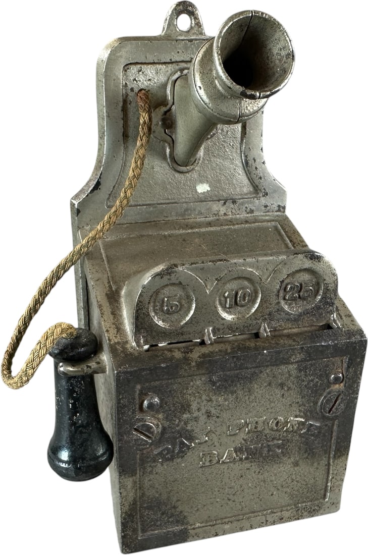 PAY PHONE MECHANICAL BANK: 105. PAY PHONE MECHANICAL BANK | J&E Stevens Co., Patented 1928, accepts nickel, dime or quarters, side crank allows bell ringing. Ex: Seamans Collection. Provenance: The Robert Booth Jr. Collection.