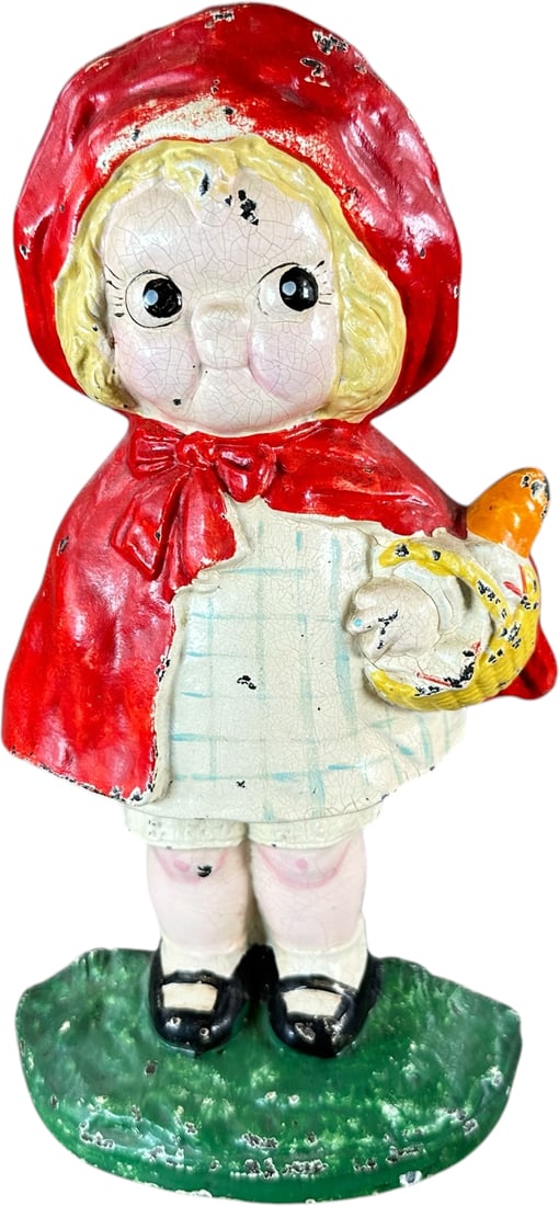 HUBLEY LITTLE RED RIDING HOOD DOORSTOP: 124. HUBLEY LITTLE RED RIDING HOOD DOORSTOP | Design by Grace Drayton, depicts brightly eyed rendition of Red Riding Hood in familiar red cape with basket of goodies. Ex: The Bob Brady Collection. |