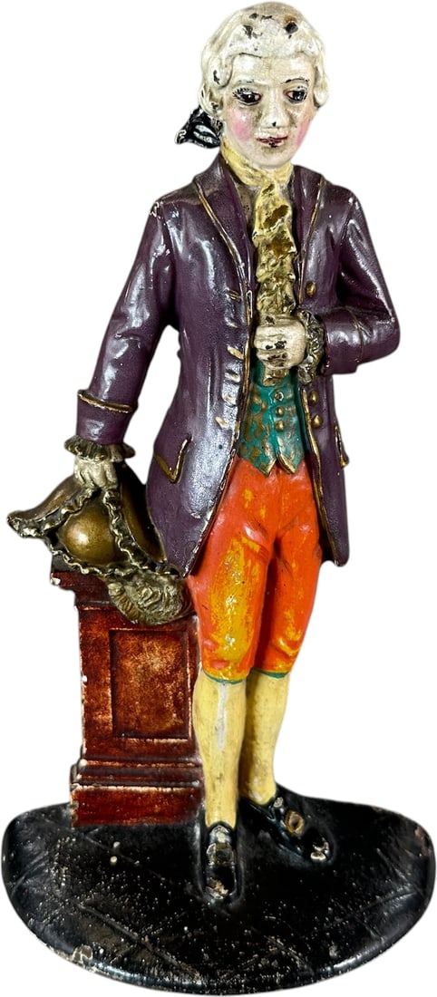 COLONIAL LAWYER DOORSTOP: 132. COLONIAL LAWYER DOORSTOP | Marked "Pat. Applied for," Waverly Studios, depicts colonial man at desk in period dress. Ex: The Bob Brady Collection. | 10" h. | Great patina, (Pristine Condition) |