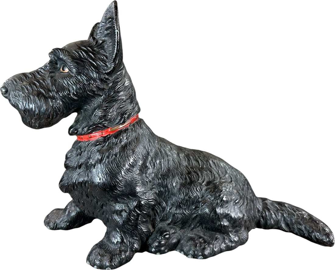 HUBLEY SITTING SCOTTIE DOORSTOP: 141. HUBLEY SITTING SCOTTIE DOORSTOP | Largest size full figure, black fur dog sitting in repose with painted red collar, great casting details. Ex: The Bob Brady Collection. | 11" h. | (Near Mint Con