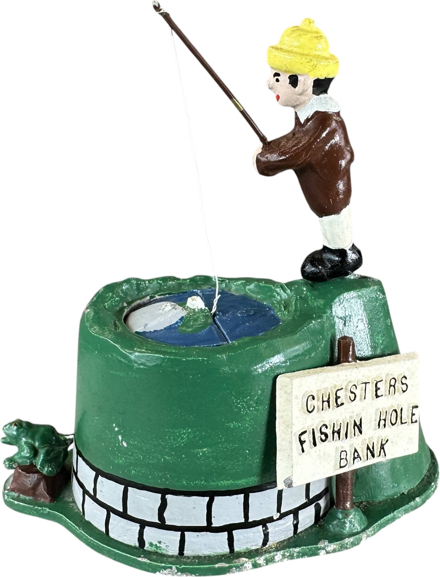 REYNOLDS CHESTERS FISHING HOLE MECHANICAL BANK: 226. REYNOLDS CHESTERS FISHING HOLE MECHANICAL BANK | Catalogue # 17-M, 1974, Edition of 10. Ex: Max Berry Collection. | 6" h. | (Excellent Condition) | $300 - $500