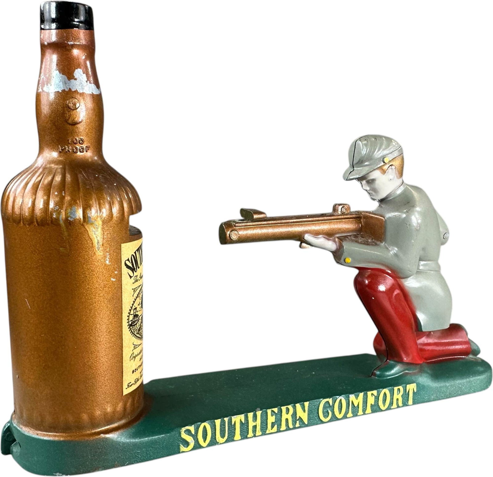 SOUTHERN COMFORT MECHANICAL BANK: 261. SOUTHERN COMFORT MECHANICAL BANK | Made by the Southern Comfort Corporation in St. Louis, Missouri circa1955. Ex: Max Berry Collection. | 8.5" l. | Minor chipping to bottle, overall (Pristine Con