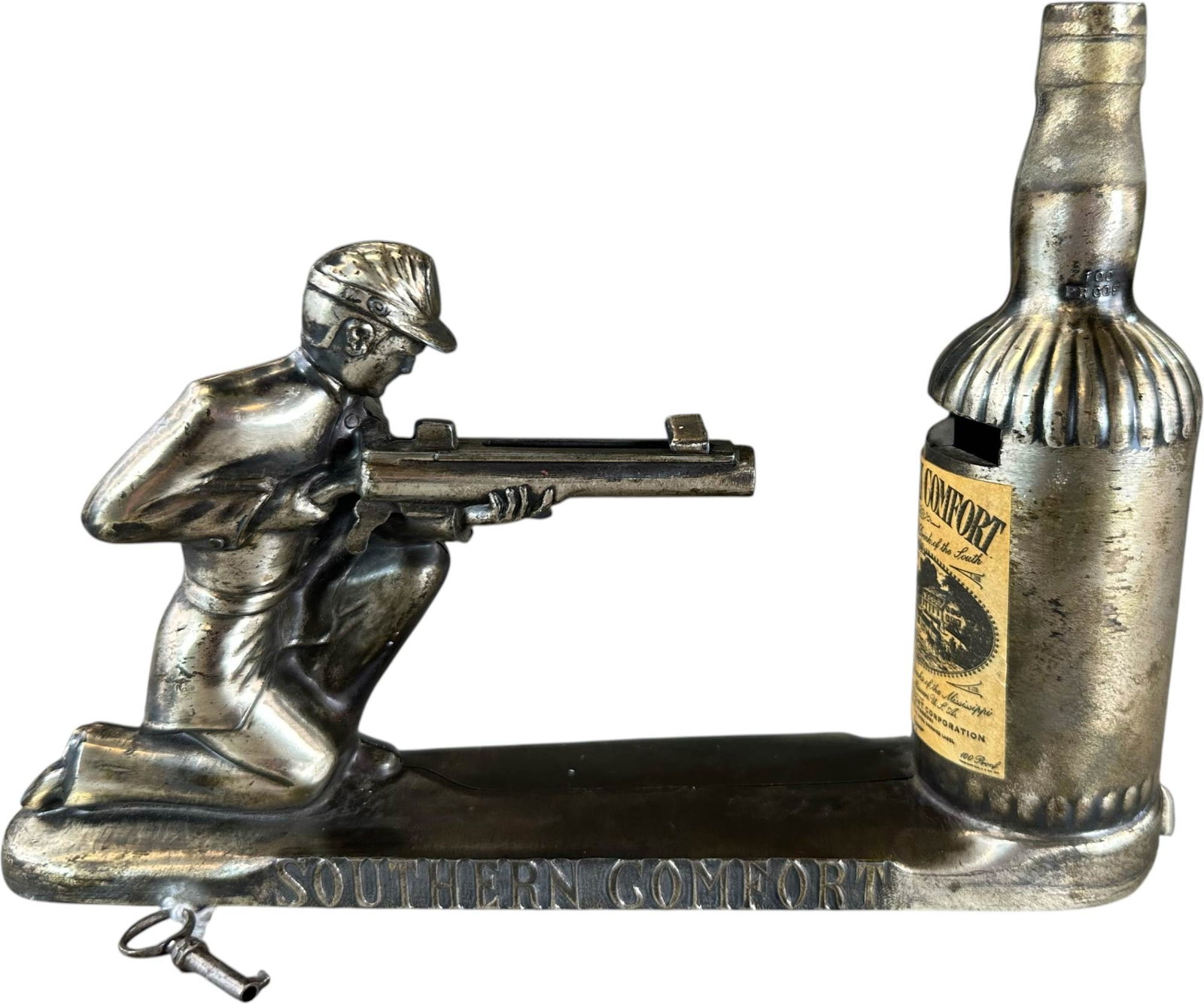 SOUTHERN COMFORT MECHANICAL BANK: 262. SOUTHERN COMFORT MECHANICAL BANK | Made by the Southern Comfort Corporation in St. Louis, Missouri circa1955. Ex: Max Berry Collection. | 8.5" l. | (Pristine Condition) | $75 - $150
