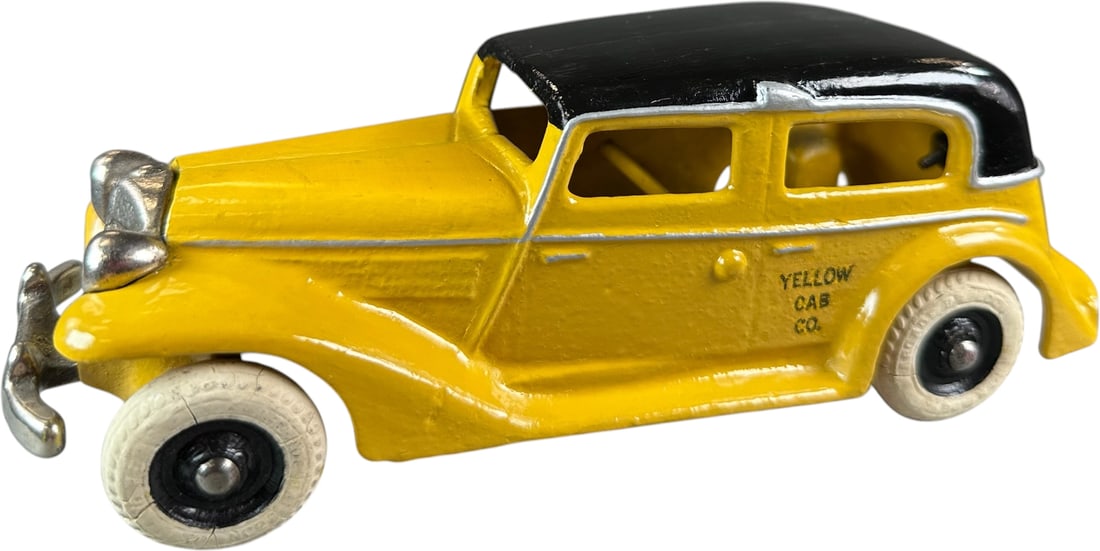 ARCADE PARMALEE YELLOW CAB: 307. ARCADE PARMALEE YELLOW CAB | Provenance: Ira Bernstein Collection. | 8.5" l. | Overpaint with lacquer to top surface of car, displays like old store stock | $400 - $700