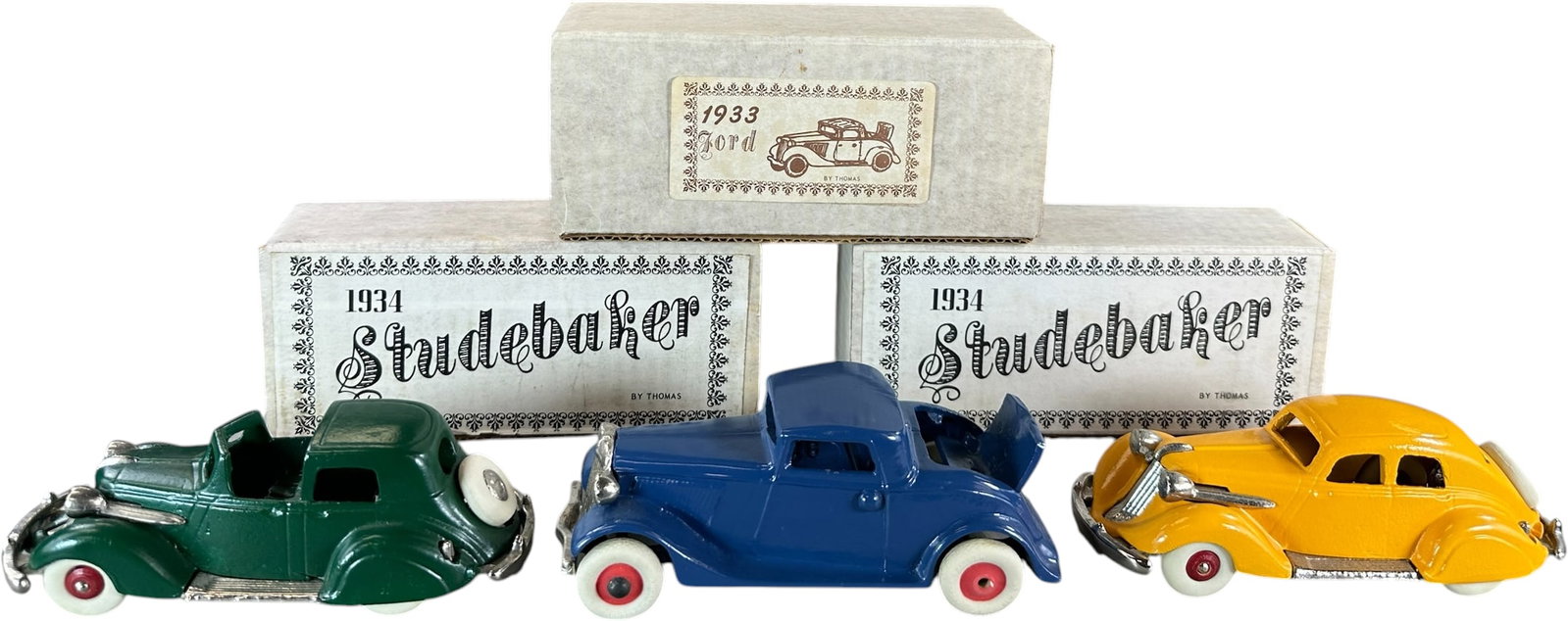 BOXED THOMAS TOYS STUDEBAKERS W/ 1933 FORD: 357. BOXED THOMAS TOYS STUDEBAKERS W/ 1933 FORD | Provenance: Ira Bernstein Collection. | 6.5" l. | Contemporary, (Near Mint Condition) | $200 - $400