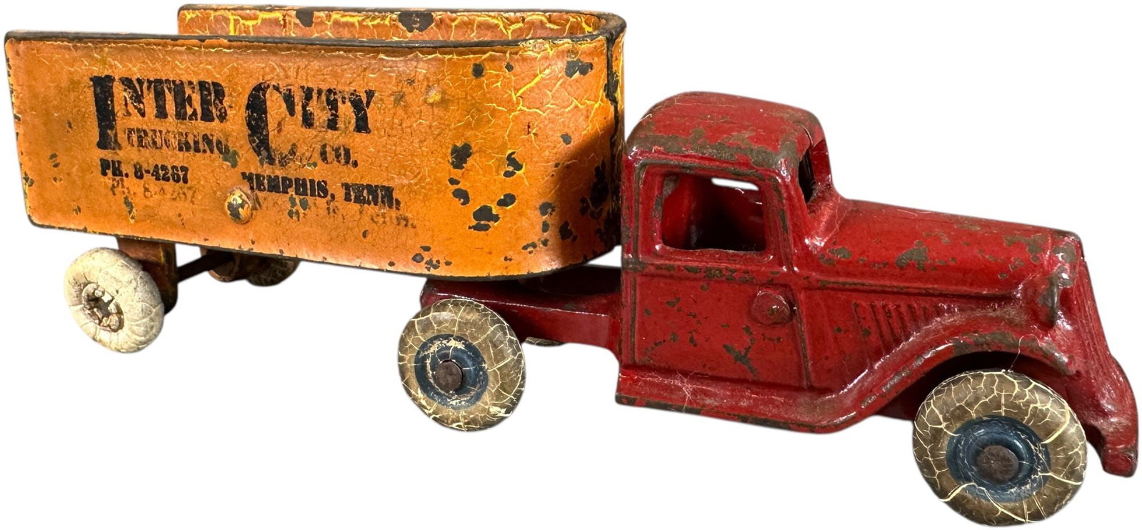 ARCADE INTER CITY TRANSPORT TRUCK: 397. ARCADE INTER CITY TRANSPORT TRUCK | Scarce example. Ex: Tony Lasala Collection. | 7.5" l. | Two original wheels loose at hubs, one replaced wheel, authentic paint and decal, (Very Good