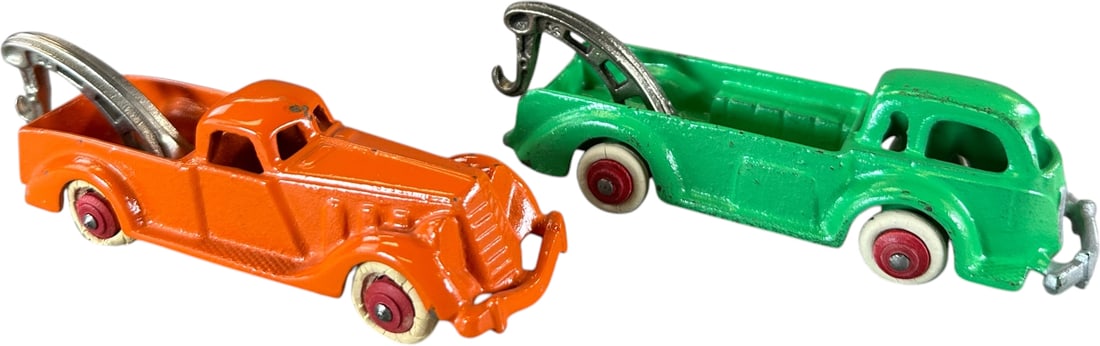 TWO HUBLEY 1940S WRECKER TRUCKS: 430. TWO HUBLEY 1940S WRECKER TRUCKS | Provenance: Ira Bernstein Collection. | 5.5" l. | Green has handling wear (Excellent Condition), orange car in (Pristine to Near Mint Condition) | $200 - $400