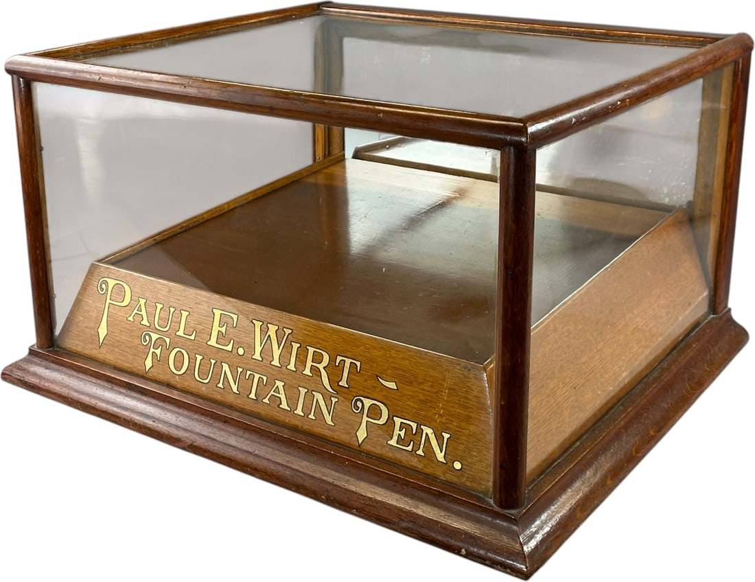 PAUL E WIRT FOUNTAIN PEN GLASS DISPLAY CASE: 21. PAUL E WIRT FOUNTAIN PEN GLASS DISPLAY CASE | 21" l. | (Pristine Condition) | $250 - $450
