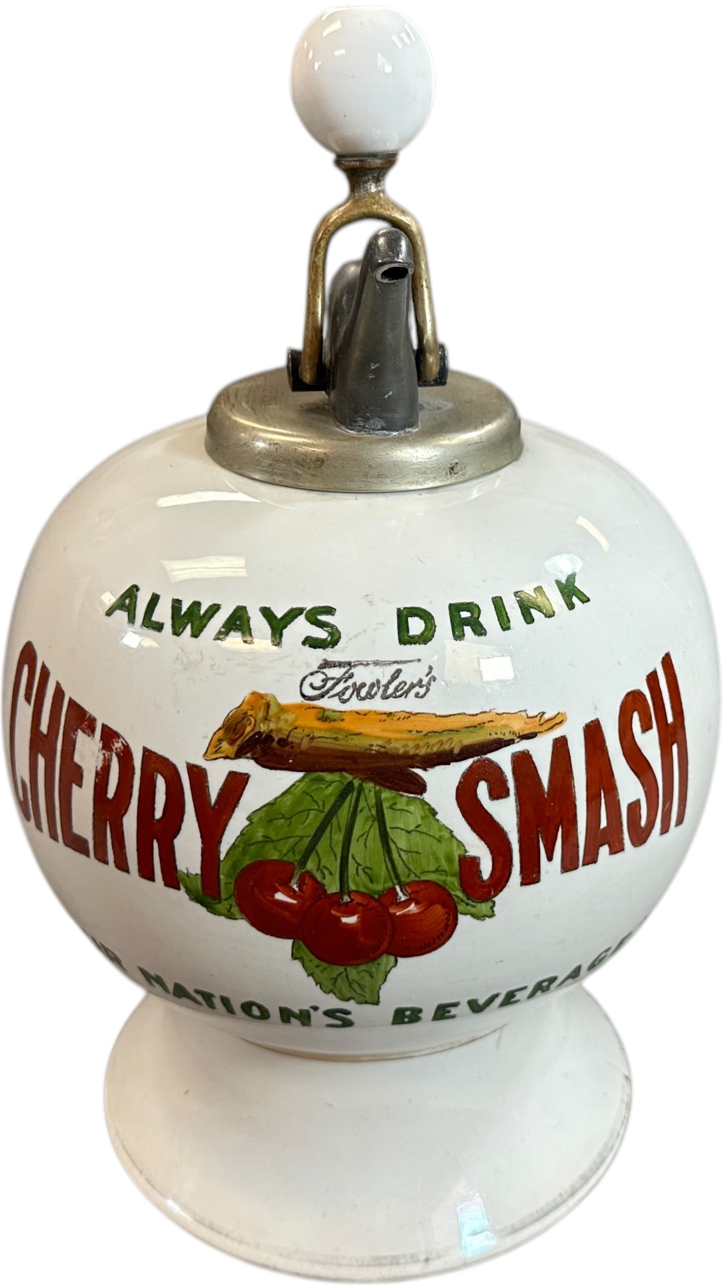 CHERRY SMASH SYRUP DISPENSER: 51. CHERRY SMASH SYRUP DISPENSER | Early ceramic soda fountain syrup dispenser featuring colorful hand-painted cherry graphics and the slogans Always Drink and Nations Beverage. Complete with metal