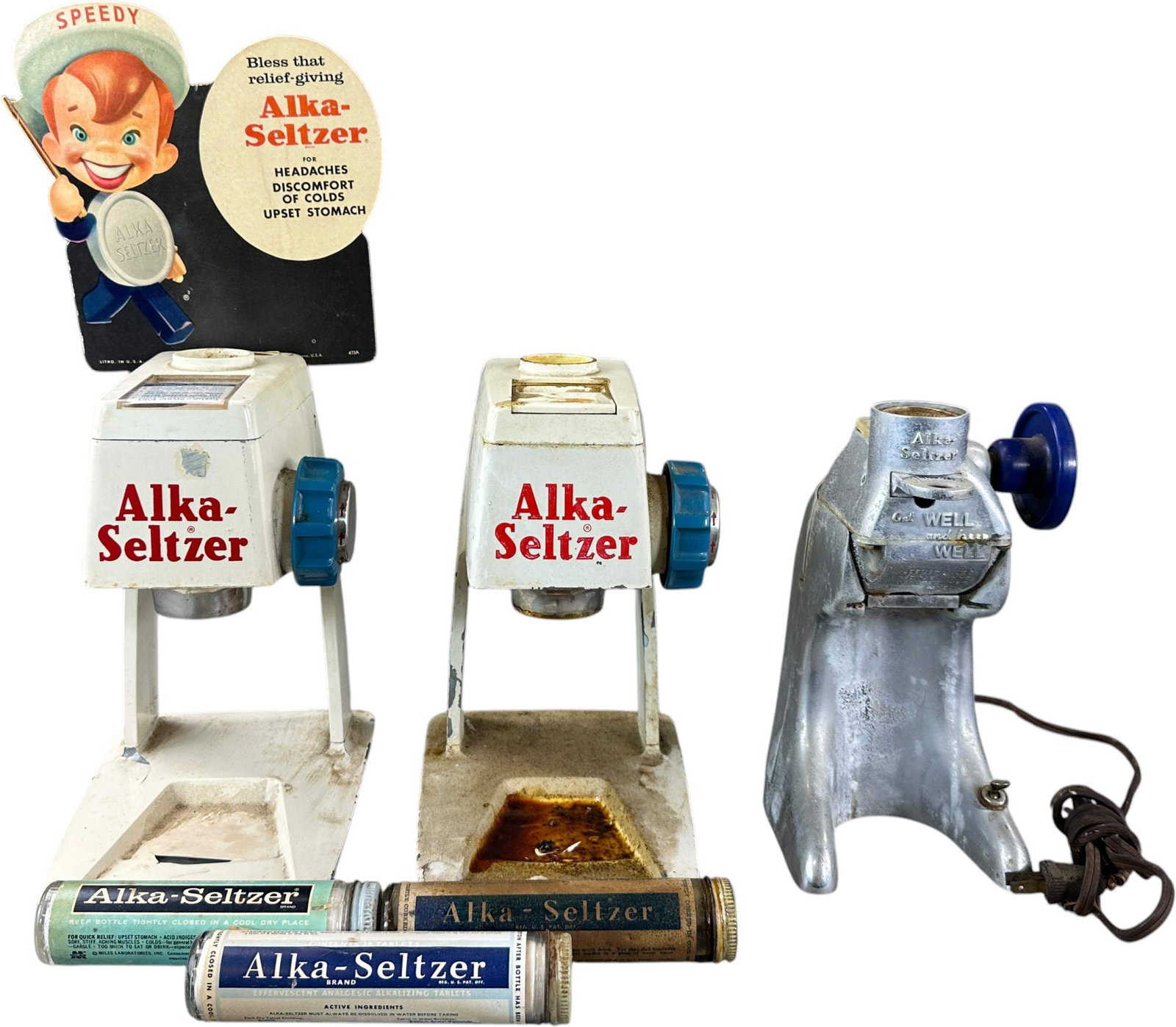 THREE ALKA SELTZER DISPENSERS: 103. THREE ALKA SELTZER DISPENSERS | 17" h. | Speedy cardboard sign attached to one; dispensers need cleaning | $200 - $400