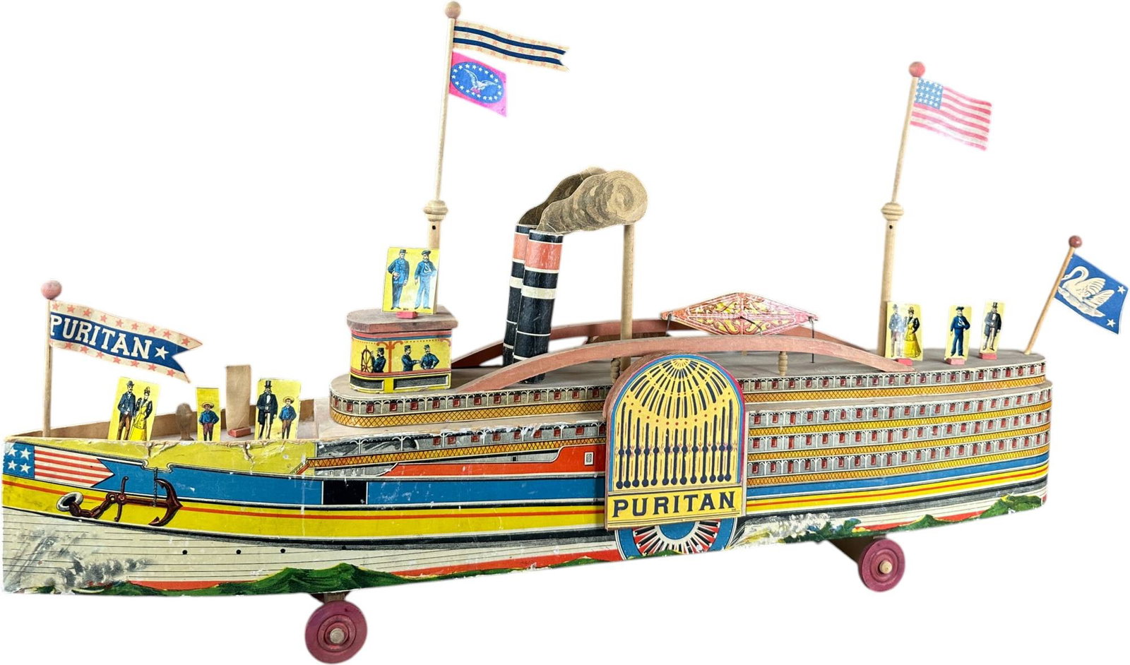 REED PURITAN PADDLEWHEEL BOAT: 174. REED PURITAN PADDLEWHEEL BOAT | Provenance: Richard Mueller Collection. | Given the age and inherently fragile nature of these paper-lithographed wood toys, staining, tears, repairs,