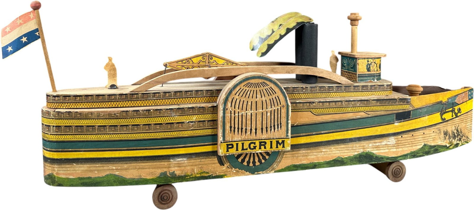 REED PILGRIM PADDLE WHEEL BOAT: 178. REED PILGRIM PADDLE WHEEL BOAT | Provenance: Richard Mueller Collection. | Given the age and inherently fragile nature of these paper-lithographed wood toys, staining, tears, repairs, restoration