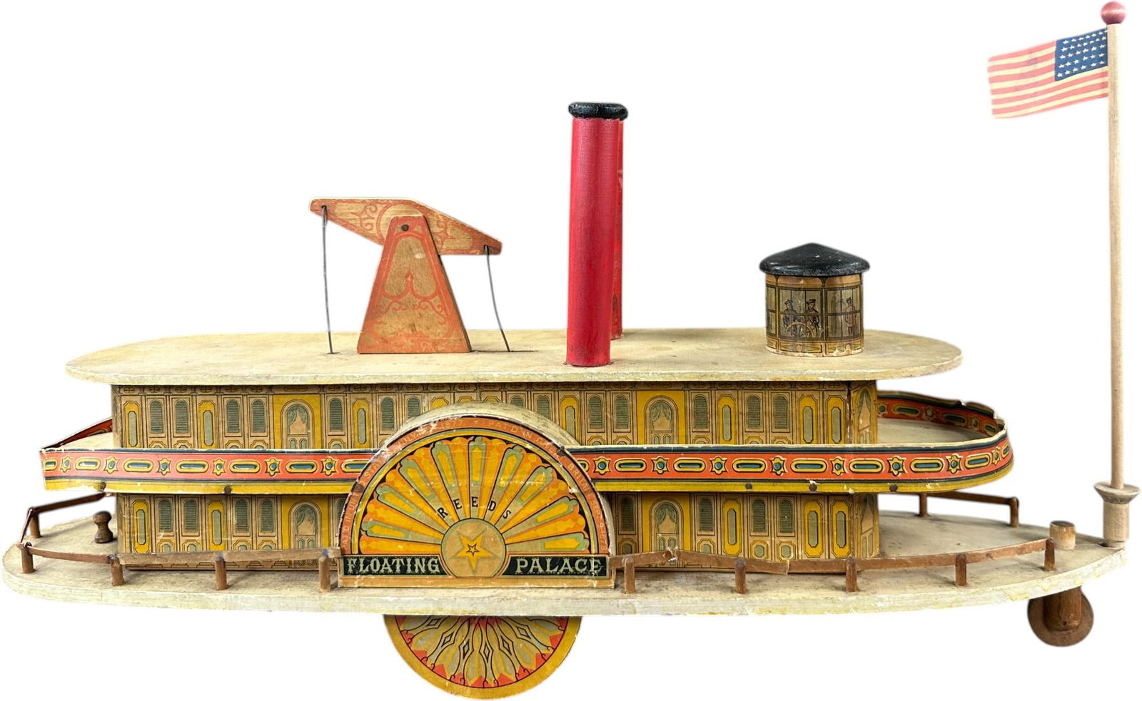 REED FLOATING PALACE RIVER BOAT: 185. REED FLOATING PALACE RIVER BOAT | Scarce variation. Provenance: Richard Mueller Collection. | Given the age and inherently fragile nature of these paper-lithographed wood toys, staining, tears, r