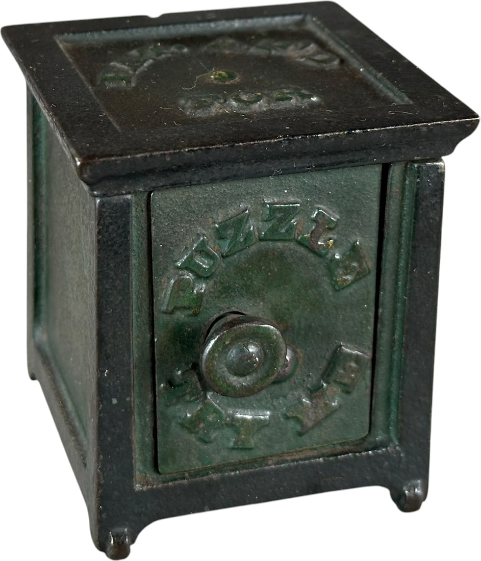 PUZZLE TRY ME SAFE STILL BANK: 378. PUZZLE TRY ME SAFE STILL BANK | Unknown maker, c. 1868. | 2.5" h. | Would benefit from a cleaning to brighten green paint, (Excellent Condition) | $400 - $700