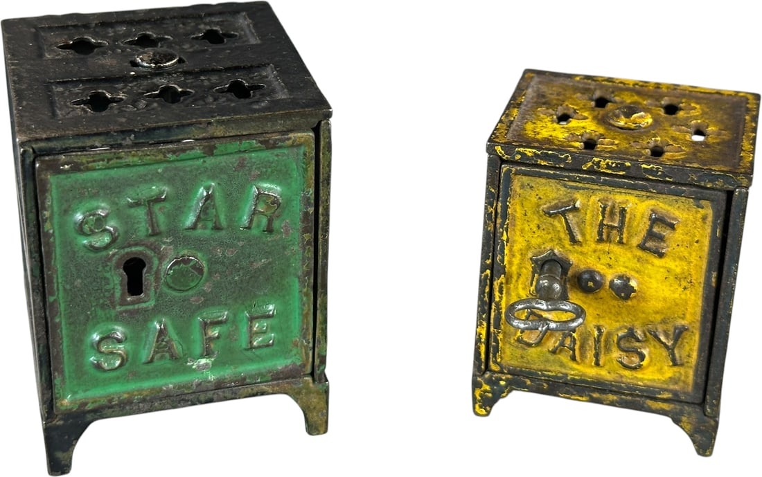 STAR & DAISY SAFE STILL BANKS: 379. STAR & DAISY SAFE STILL BANKS | Star, Kyser & Rex, c. 1882, Daisy, Shimer c, 1899, | 2.5" h. | Daisy has small casting flaw to rear cage, overall (Very Good to Excellent Condition) | $300 - $500