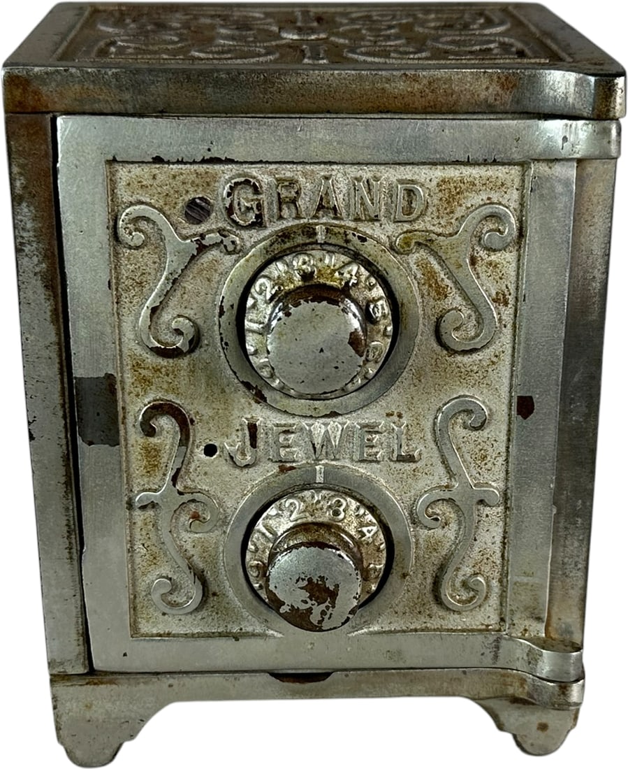 GRAND JEWEL SAFE STILL BANK: 383. GRAND JEWEL SAFE STILL BANK | Wing, c. 1895. | 5.5" h. | Partial locking mechanism missing, hairline at rear coin slot, (Very Good to Excellent Condition) | $100 - $200