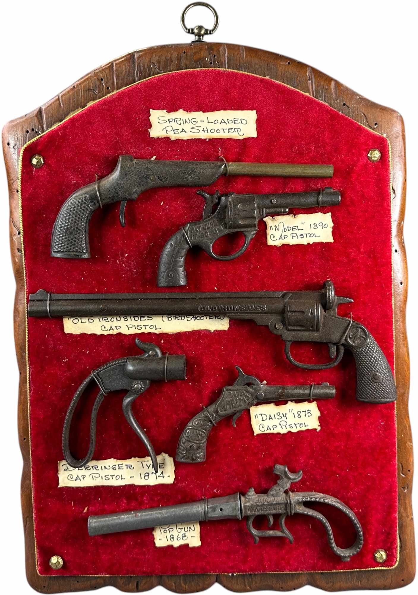 DISPLAY PLAQUE W/ SIX MOUNTED CAP GUNS: 476. DISPLAY PLAQUE W/ SIX MOUNTED CAP GUNS | 17" h. | (Very Good to Excellent Condition) | $300 - $600