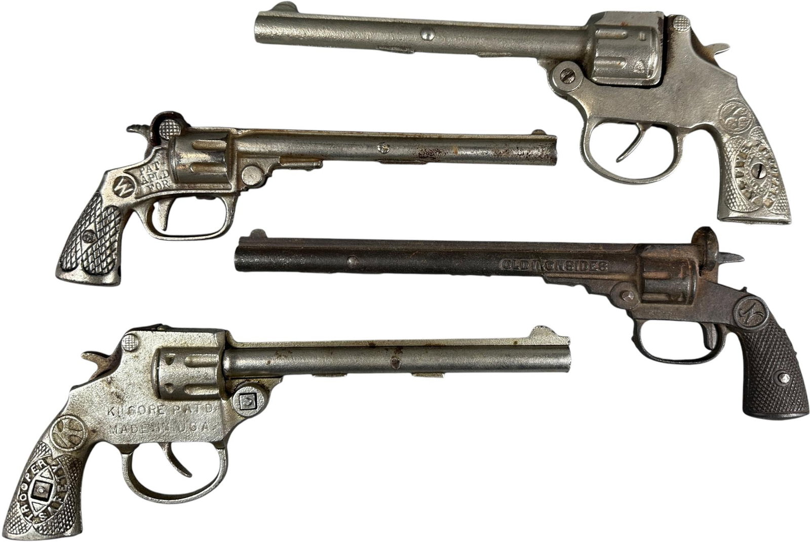 TWO TROOPERS, TWO TIME, OLD IRONSIDES CAP GUNS: 477. TWO TROOPERS, TWO TIME, OLD IRONSIDES CAP GUNS | 10.5" l. | Two Kilgore guns inoperative, Old Ironside has crack in barrel, overall (Very Good to Excellent Condition) | $150 - $300