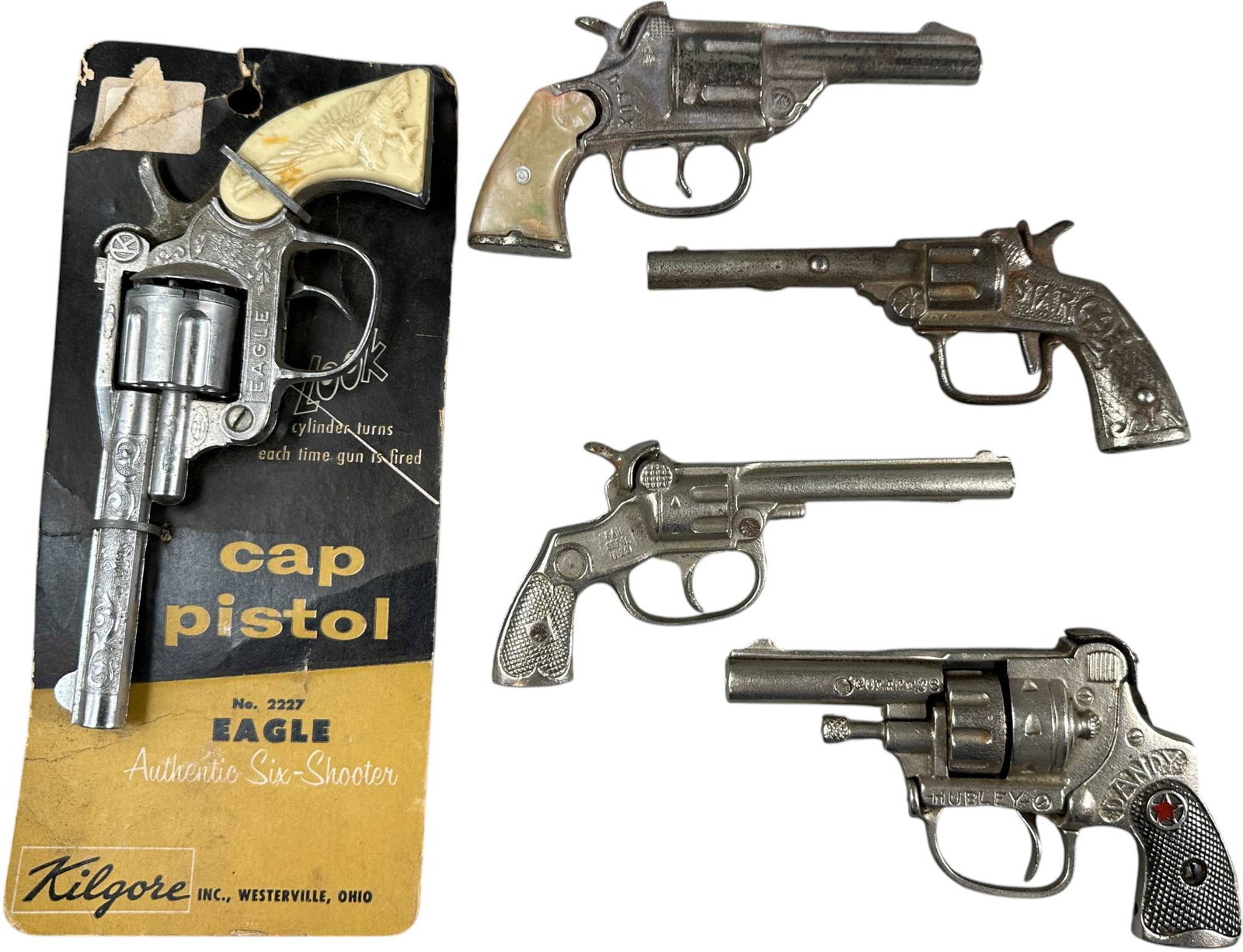 DANDY, MICK, DLUX, EAGLE AND STAR CAP GUNS: 478. DANDY, MICK, DLUX, EAGLE AND STAR CAP GUNS | Kilgore, Hubley and other makers. | 6" l. | Dandy has chip on hammer, overall (Very Good to Excellent Condition) | $150 - $300