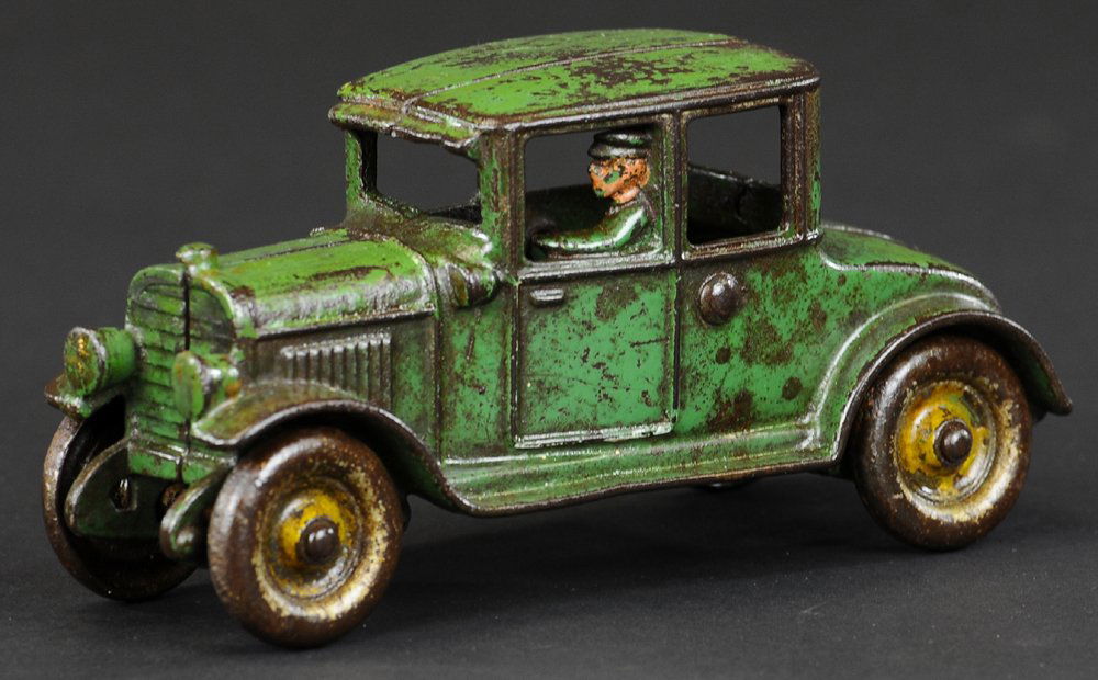 HUBLEY COUPE: Cast iron, very scarce example, painted in green body, features cast driver at window, disc wheels. 6 3/4" l.