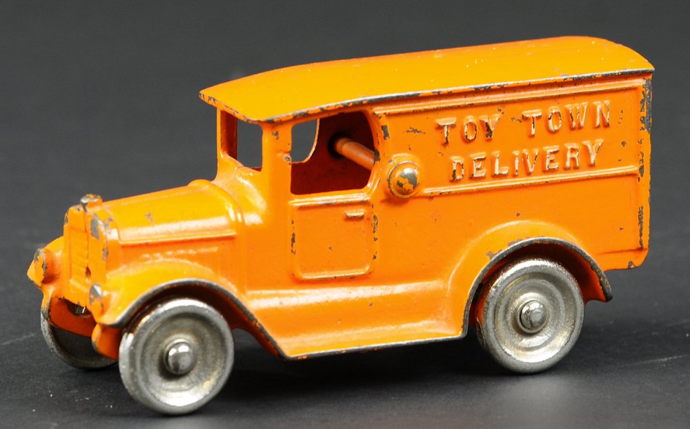 KILGORE "TOY TOWN" DELIVERY TRUCK: Cast iron, painted in orange overall, embossed, "Toy Town Delivery" on sides of van, nickel disc wheels. 6" l.