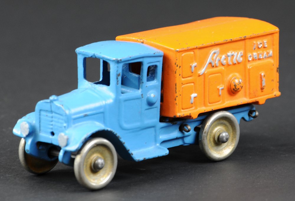 KILGORE ARCTIC ICE CREAM TRUCK: Cast iron, enclosed cab done in blue, features van body in orange with embossed advertising lettering on sides. 6 1/2" l.
