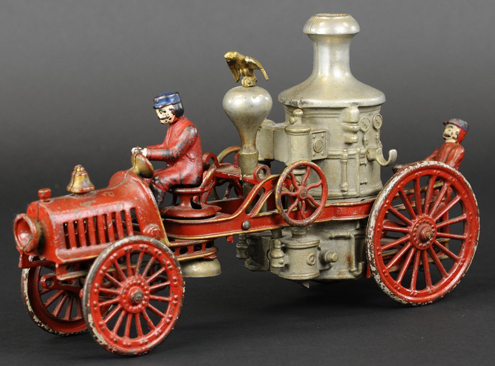 HUBLEY AUTO FIRE ENGINE: c. 1920's, cast iron, commonly referred to as a "Christie Transitional Pumper," done in red service body, slotted hood, nickel boiler, it is a rendition of a motorized unit with front driver and rear 