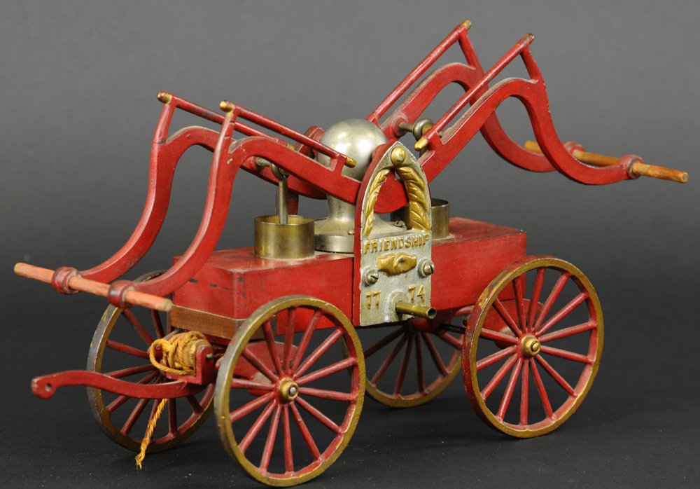 HAND PUMP FIRE ENGINE: Colark Ship Model Co., Philadelphia, c. 1930, large scale cast iron toy fire pumper, painted in red with silver boiler support, embossed "Friendship 1774," a well detailed toy fashioned from one of th
