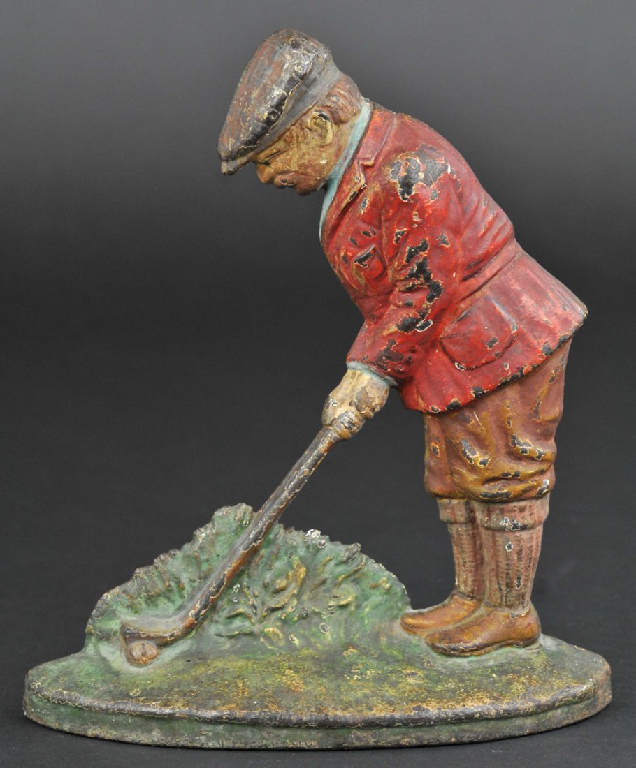 PUTTING GOLFER DOORSTOP: Hubley #34, depicts golfer dressed in 1930's golfing attire, preparing to put out of an overgrown grassy area. 8 1/2" h.
