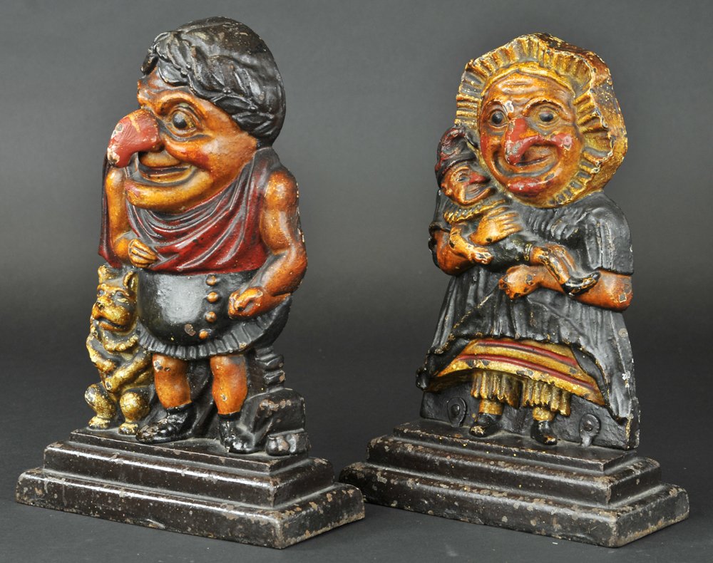 PUNCH & JUDY DOORSTOPS: English two-piece heavy castings of popular characters, punch has deep rich coloring & exaggerated facial features; Judy coddling the baby Punch. Both 12" h.