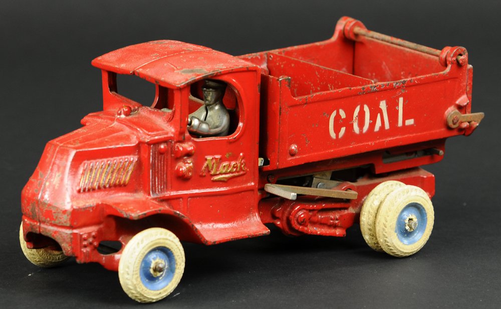 ARCADE MACK COAL TRUCK: Cast iron, painted in red overall, open dump body has partition and opening tailgate, stenciled "COAL" on sides, nickeled driver, white rubber tires. 10" l.