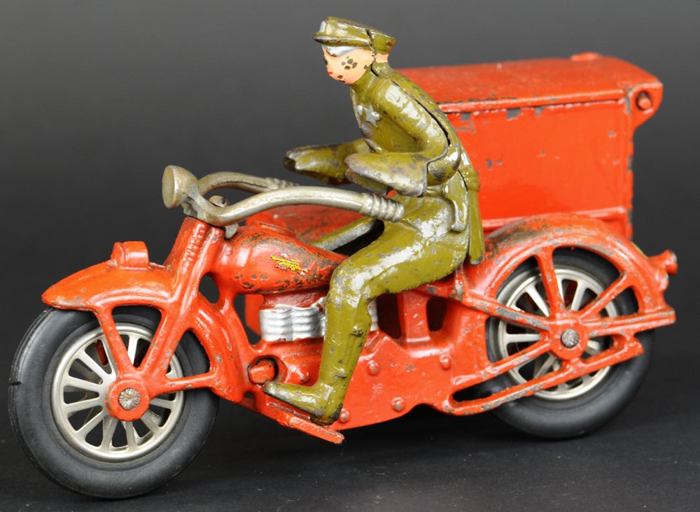 PDQ DELIVERY CYCLE WITH DRIVER: Vindex, scarce example, cast iron, painted in red overall, depicts four cylinder cycle with split level side box embossed "PDQ Delivery" on side, rubber tires, nickel spoke wheels, seated driver, part