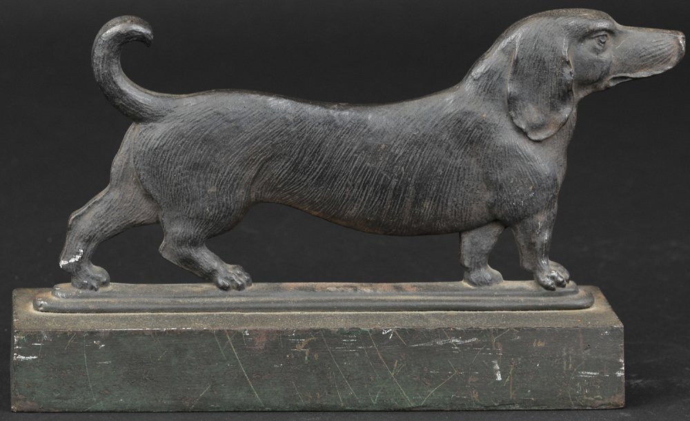 B&H DACHSHUND DOORSTOP: Extremely rare, cast iron, B&H, double sided & well casted, depicts dog with nose raised for canine scent; heavy base, one rubber knob partially intact, great quality. 6 1/2" h.