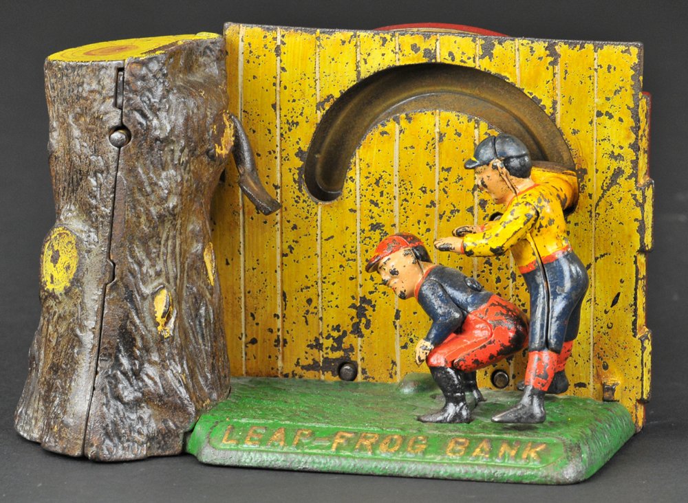 LEAP FROG MECHANICAL BANK: Shepard Hardware Co., designed by Peter Adams, patented 7/15/1890. Insert a coin in the slot at top of stump and slide the lever; one boy leapfrogs over the other and his right hand strikes a second l