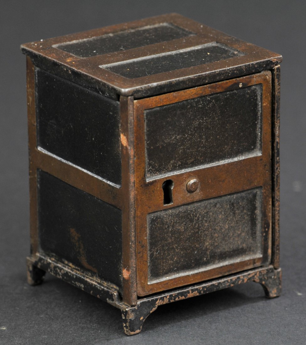 TWO PANEL DOOR SAFE STILL BANK: Cast iron, painted in black & brown, key lock door, coin slot in rear panel. 3 5/8" h.