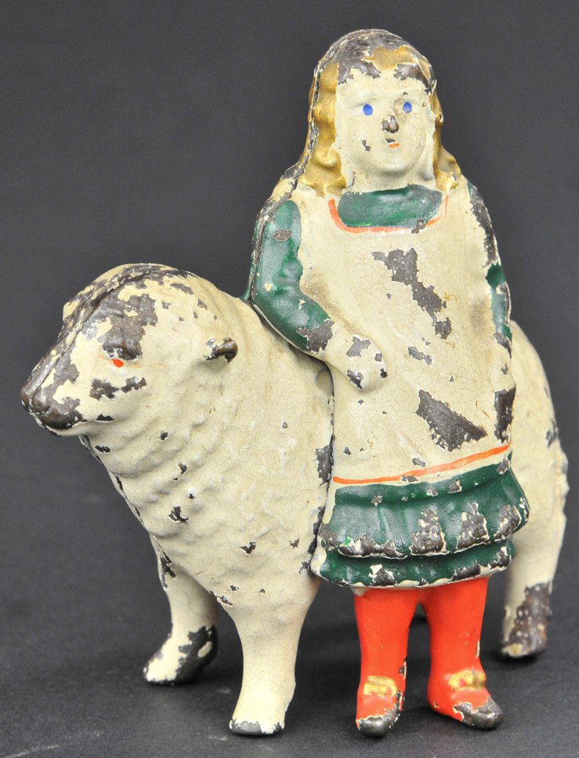 MARY & LAMB STILL BANK: Cast iron, painted white overall, depicts famed nursery rhyme character with lamb, great casting. Mary done in white dress with green trim and red stockings. 4 3/8"t.